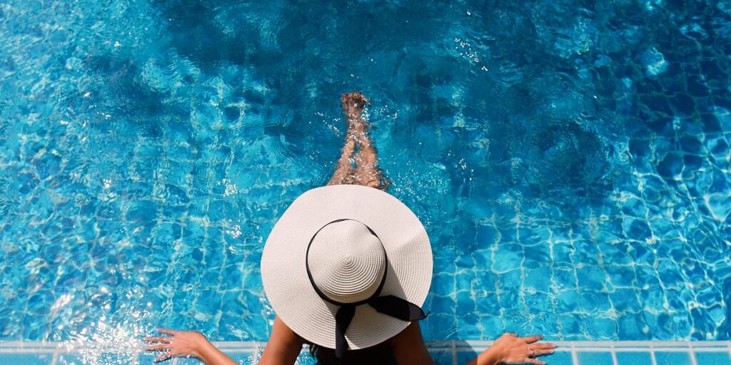 Young asian woman relaxing in swimming pool at spa resort.relaxing concept.